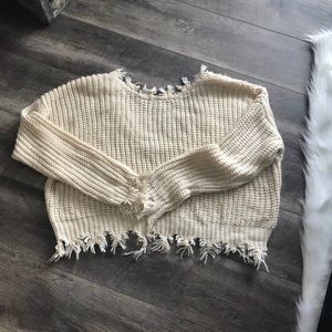 Distressed cream sweater